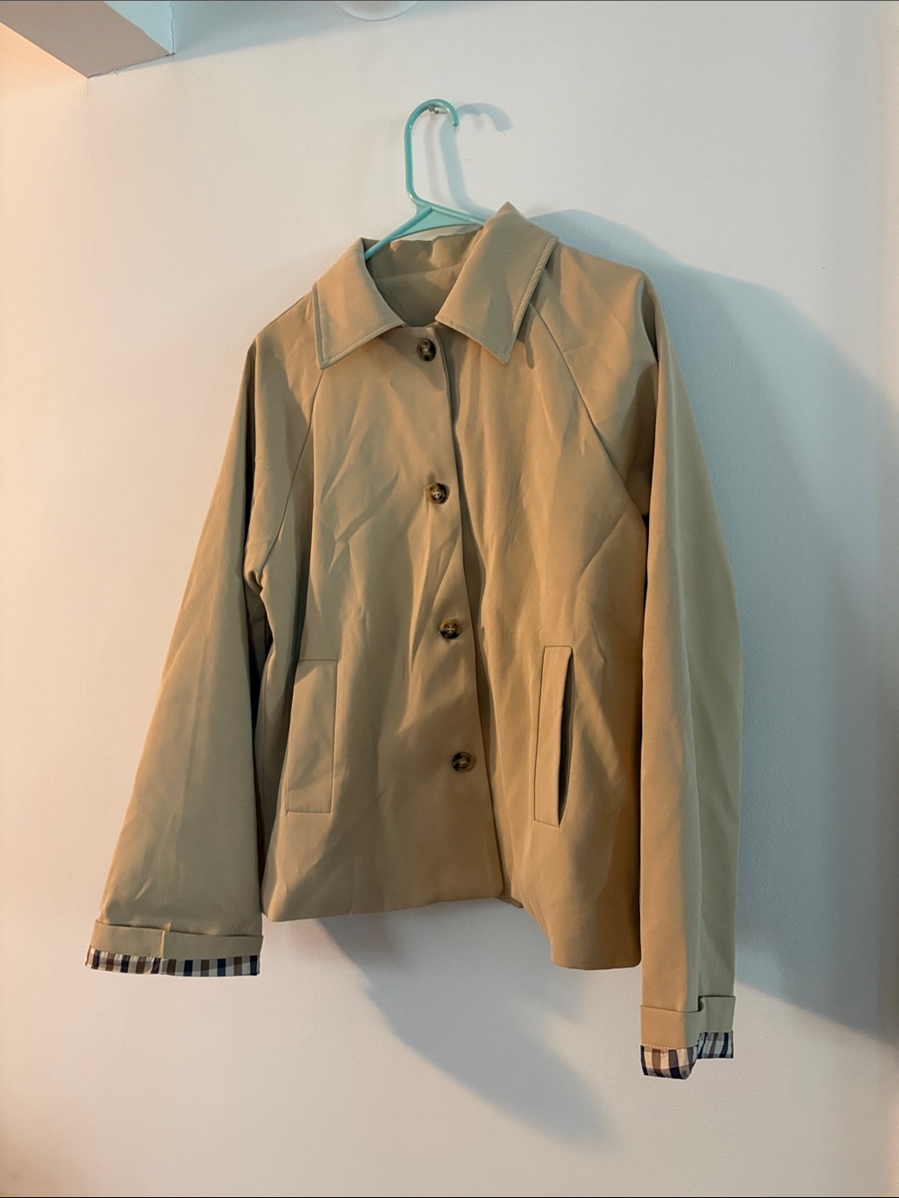 Tan button down jacket with plaid lined sleeves